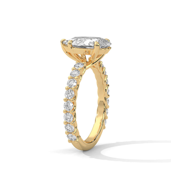 An elegant pear diamond engagement ring crafted in 14k yellow gold, highlighted by a bubble setting for a captivating 3D appearance.