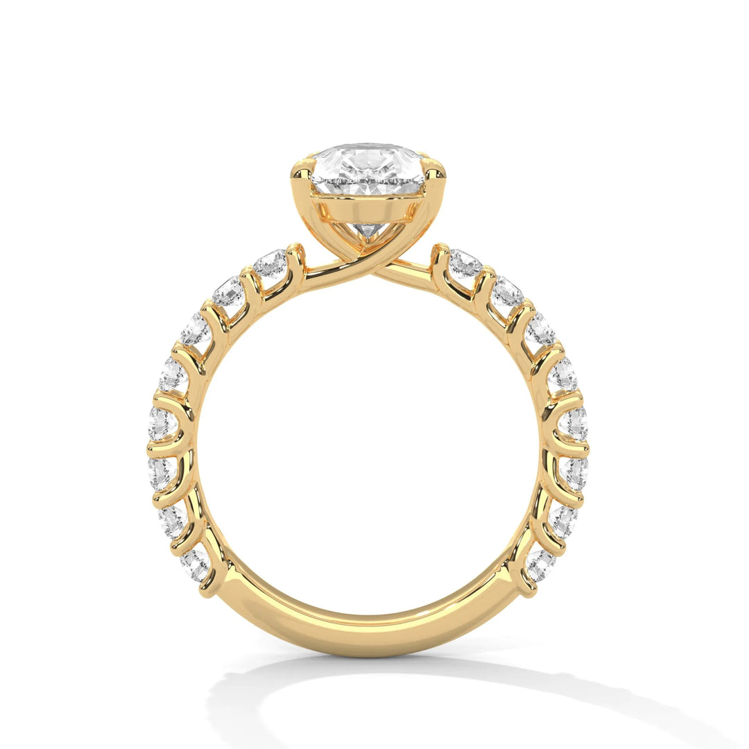 A yellow gold engagement ring with a diamond center in a bubble setting, crafted from 14k gold and featuring an pear shape.