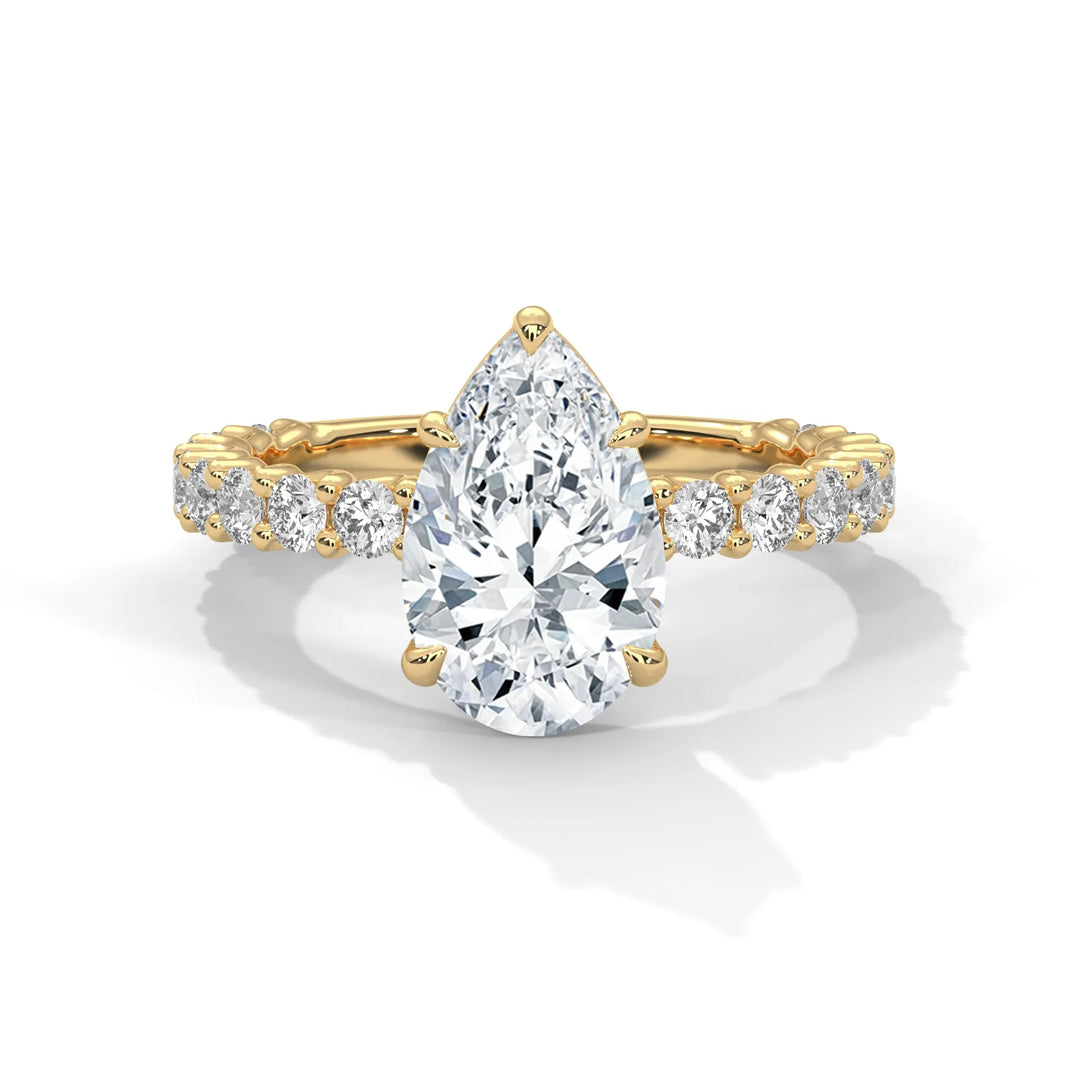 A stunning pear cut diamond engagement ring in a bubble setting, crafted from 14k yellow gold for a luxurious touch.