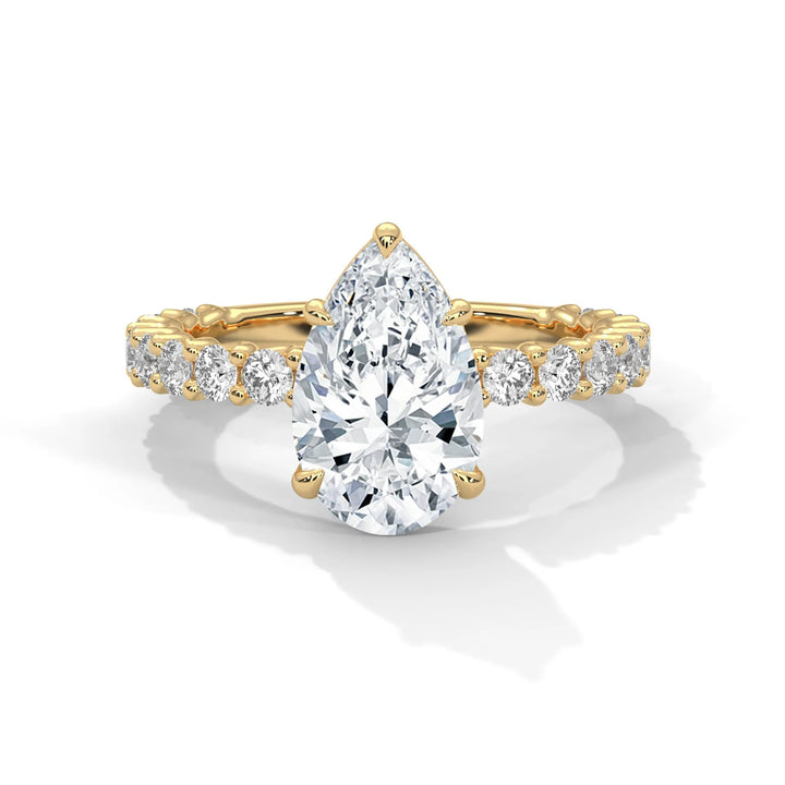 A stunning pear cut diamond engagement ring in a bubble setting, crafted from 14k yellow gold for a luxurious touch.