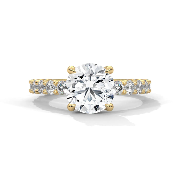 A stunning round cut diamond engagement ring in a bubble setting, crafted from 14k yellow gold for a luxurious touch.