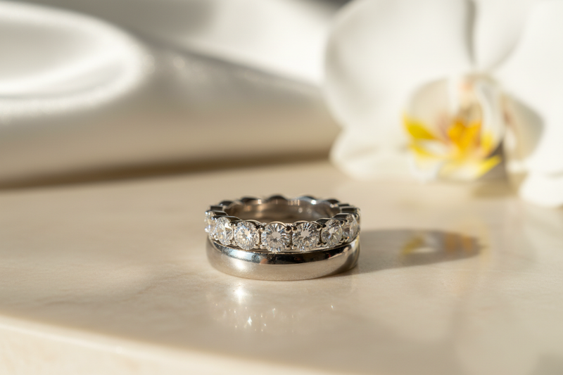 Diamond anniversary band stacked with wedding band, soft natural lighting, luxury lifestyle jewelry photography