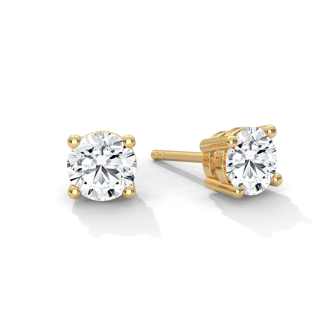 Diamond stud earrings set in elegant yellow gold showcasing a timeless and sophisticated design. Perfect for any occasion.