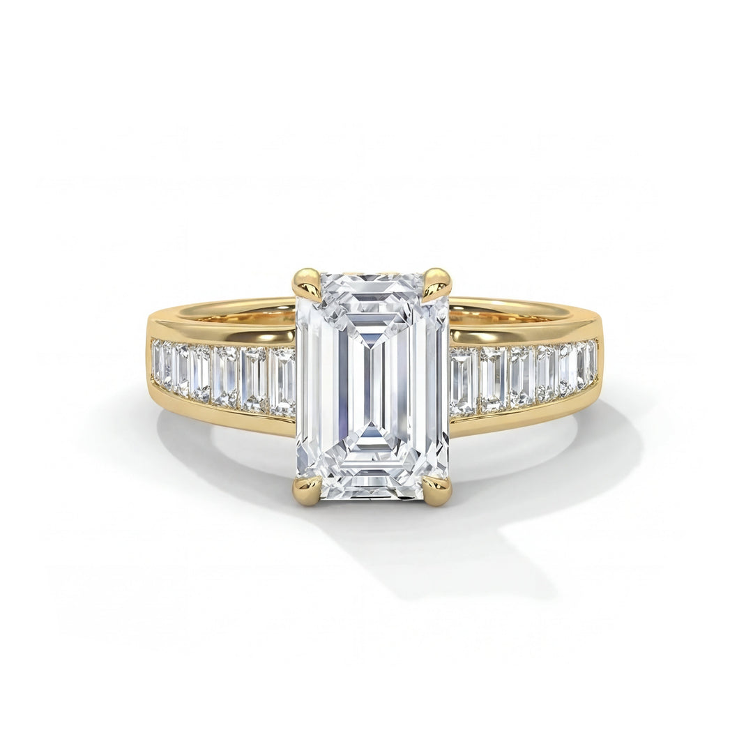 Elegant emerald-cut diamond ring set in gold, featuring smaller baguette diamonds on the band. The ring conveys luxury and sophistication.