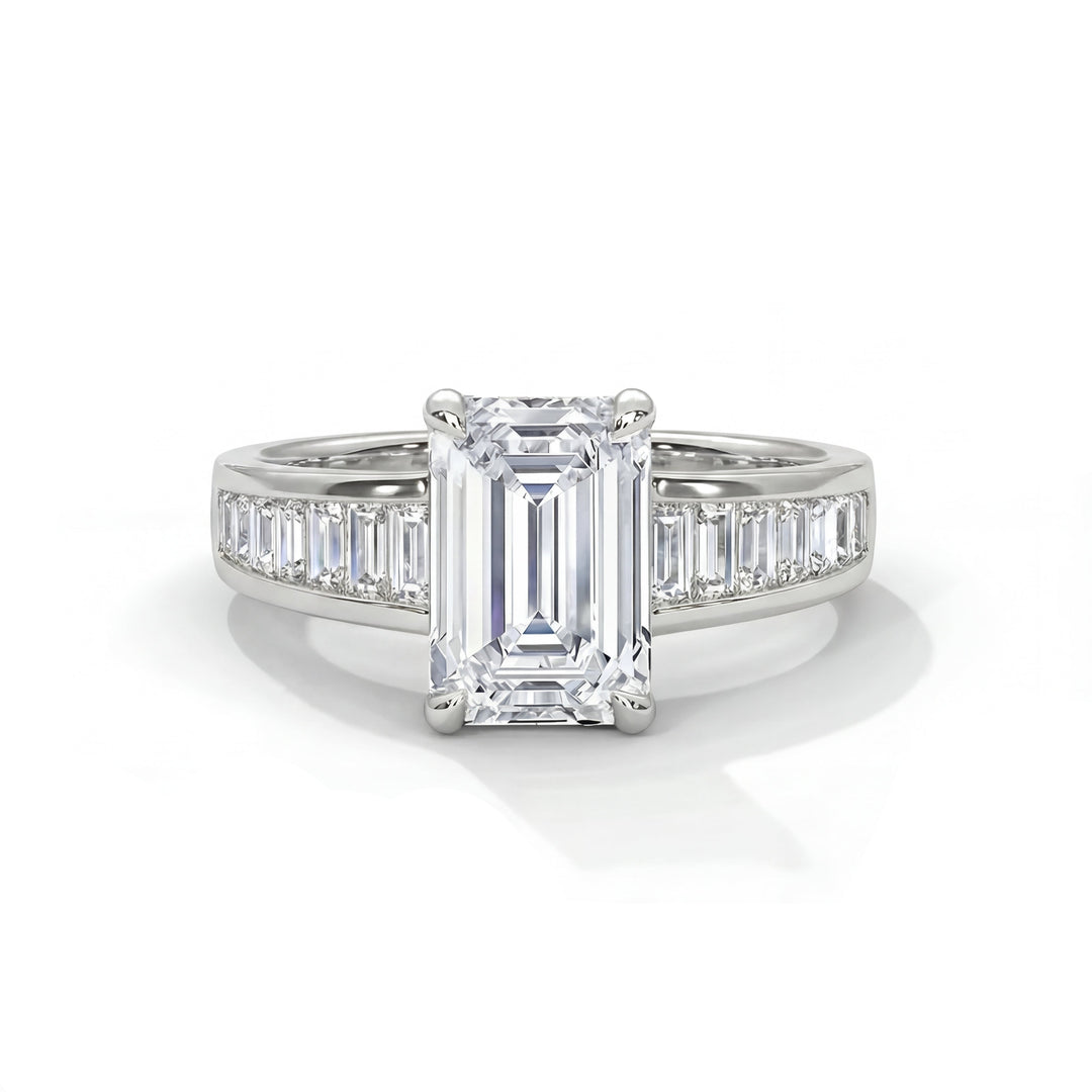 Elegant emerald-cut diamond ring with side baguette diamonds in a platinum band, reflecting light and exuding luxury and sophistication.