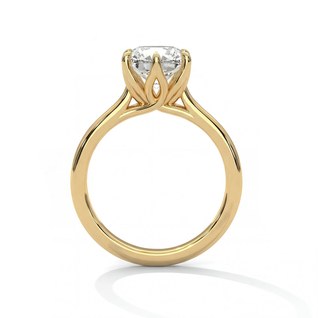 Elegant gold engagement ring with a large round diamond in a floral-inspired prong setting. The design is sophisticated and luxurious.