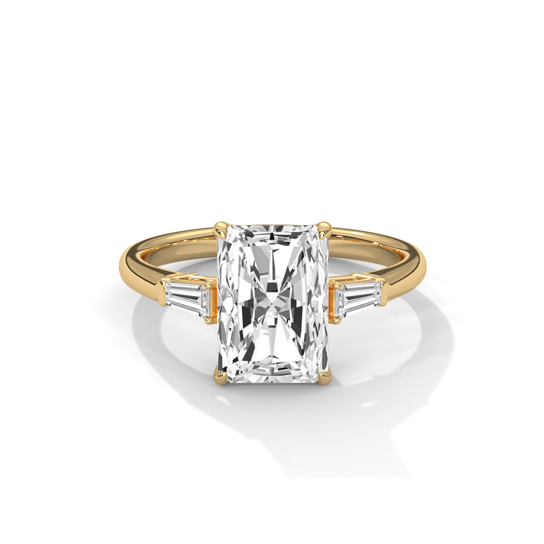 Elegant gold ring featuring a large rectangular radiant-cut diamond center stone with two tapered baguette diamonds on each side.