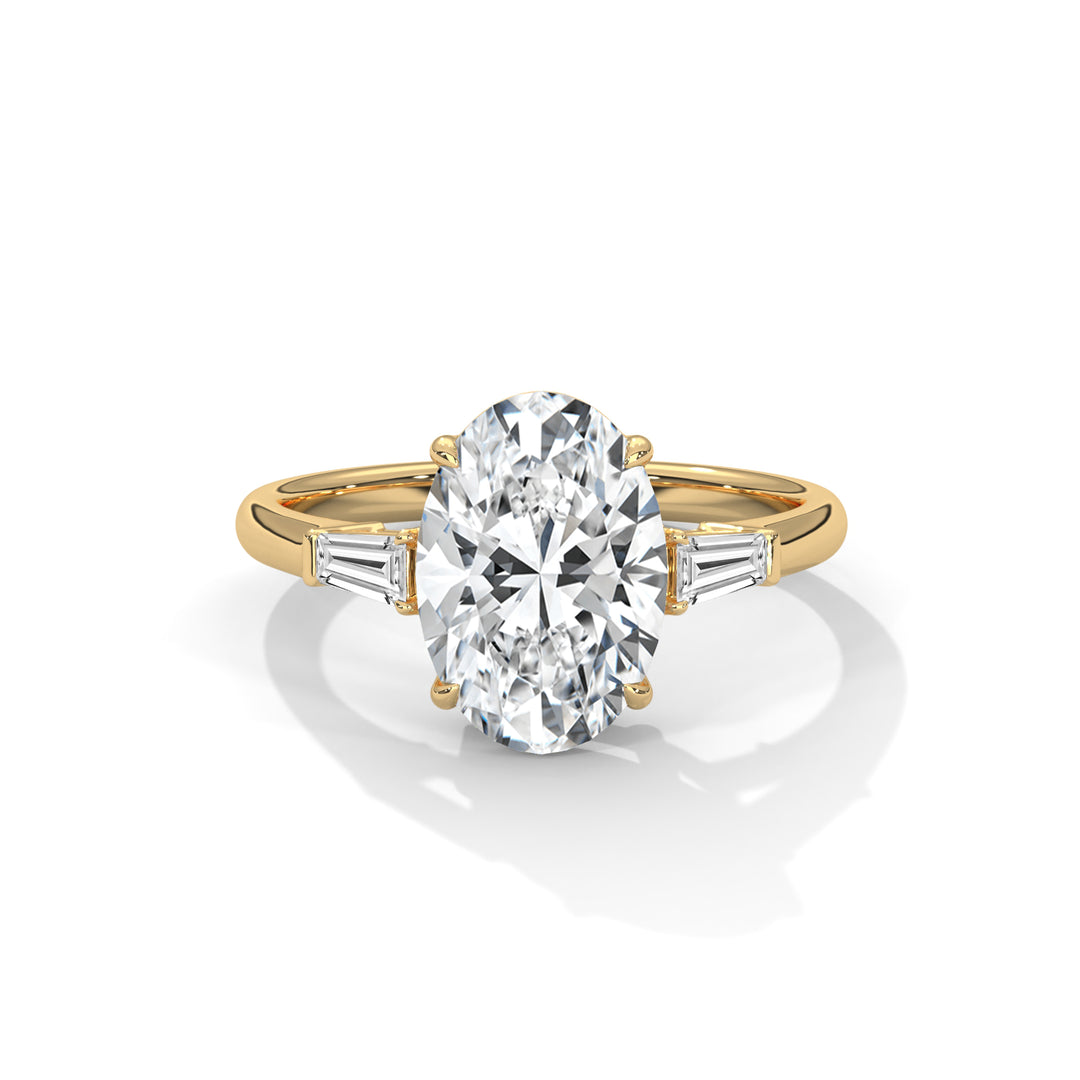 Elegant gold ring featuring a large, sparkling oval diamond at the center, flanked by two tapered baguette diamonds on each side, exuding luxury and sophistication.