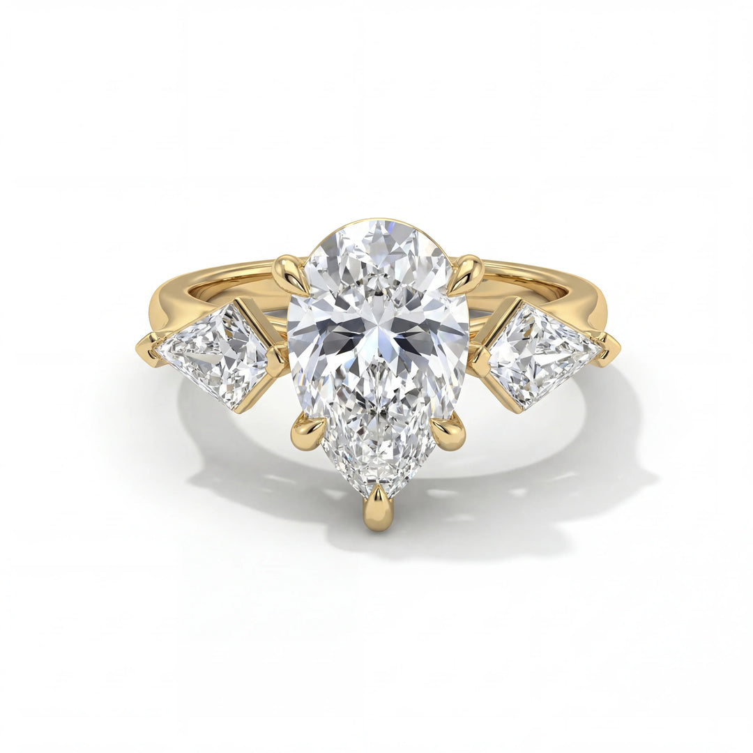 Elegant gold ring featuring a pear-shaped diamond center, flanked by two triangular diamonds on each side, creating a luxurious and timeless appearance.