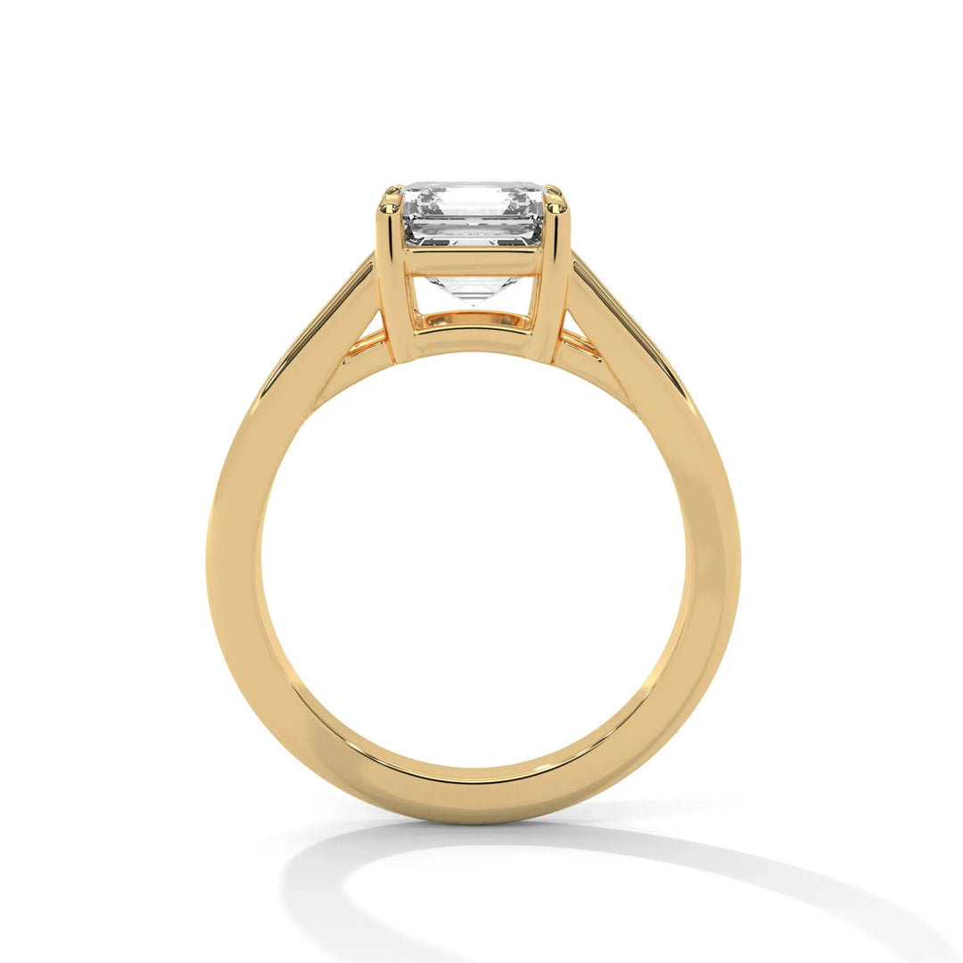 Elegant gold ring with a rectangular, clear gemstone set in a classic band. The ring's simple design exudes timeless sophistication and luxury.