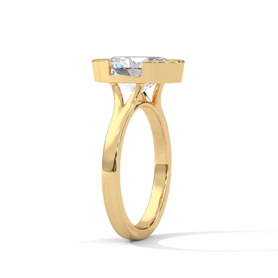 Elegant gold ring with a sleek band featuring a large, rectangular diamond set in a modern design. It conveys luxury and sophistication.