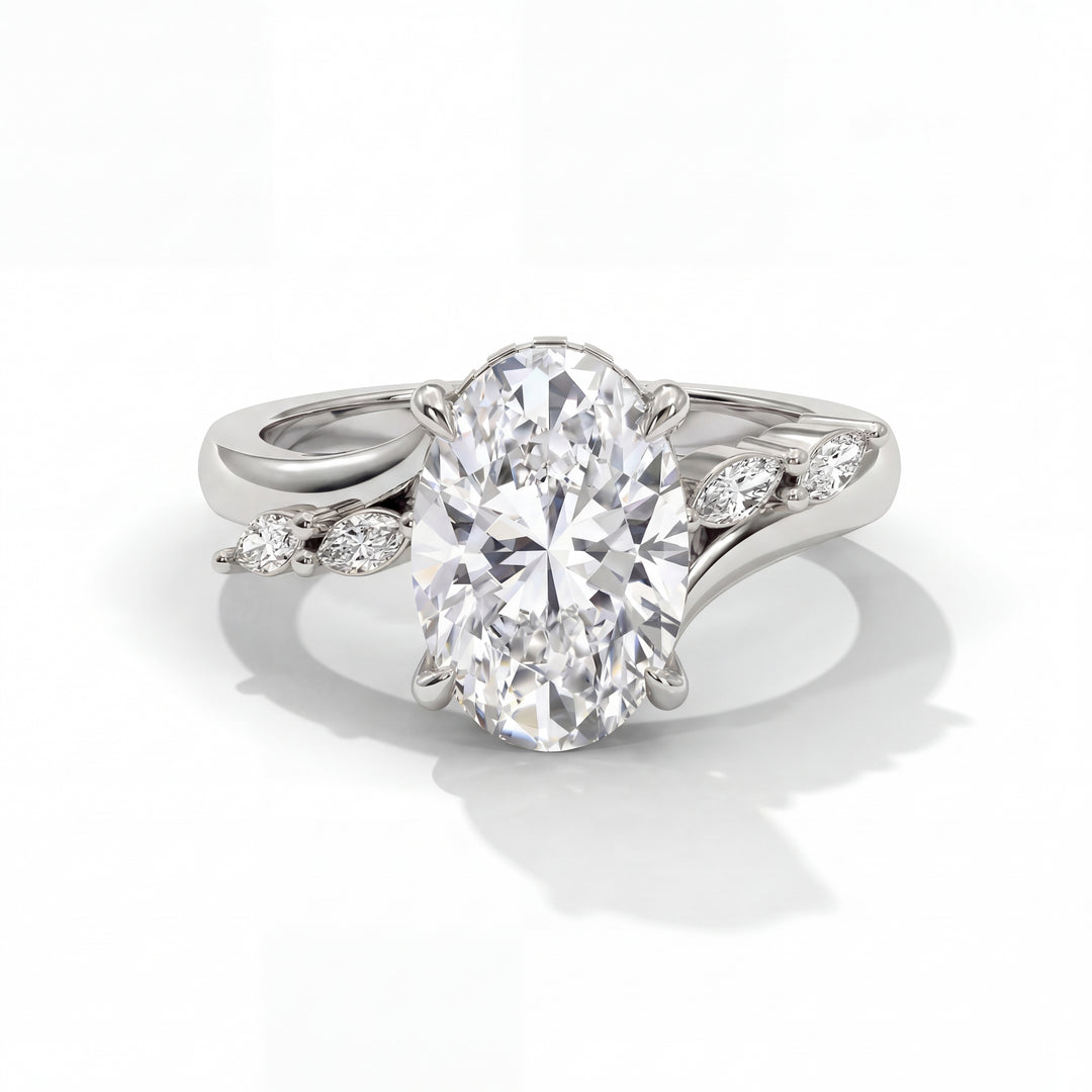 Elegant platinum ring with large oval diamond center stone and two marquise diamond side stones. The setting is intricate, elegant, and sophisticated.