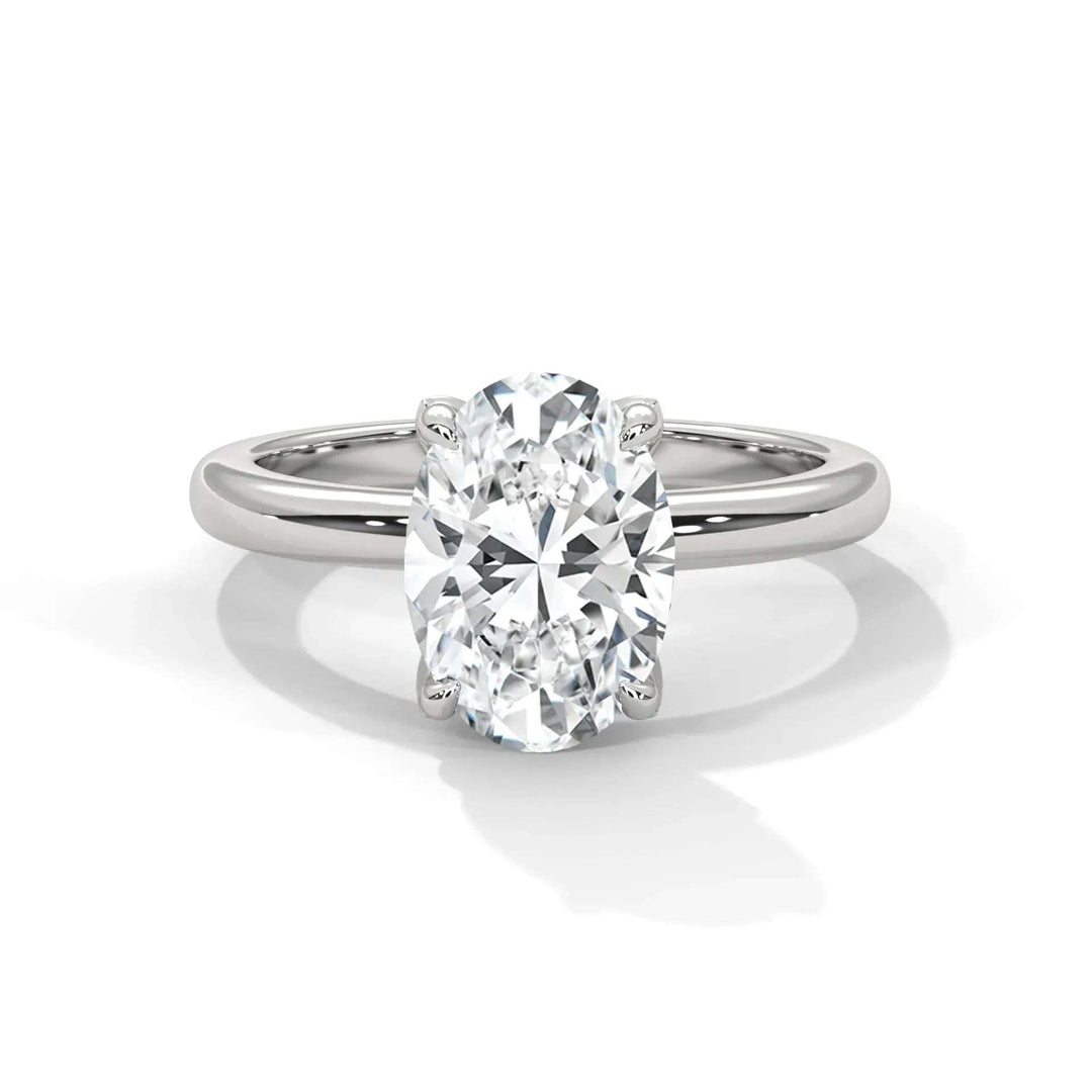 Elegant silver ring with an oval-cut diamond centerpiece, reflecting light brilliantly. The sleek band enhances the ring’s sophisticated and timeless design.