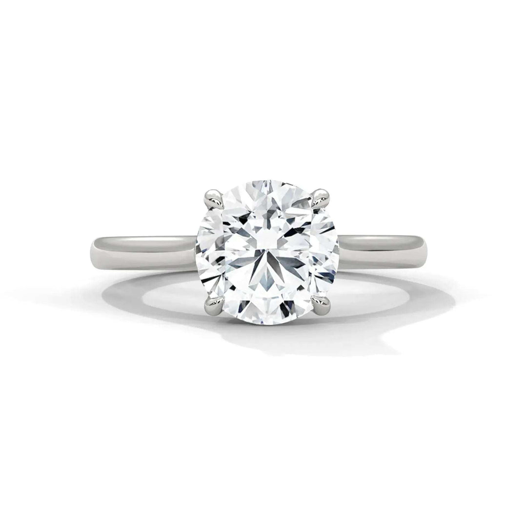 Elegant solitaire engagement ring featuring a large, round brilliant diamond set in a simple silver band, creating a classic and timeless look.