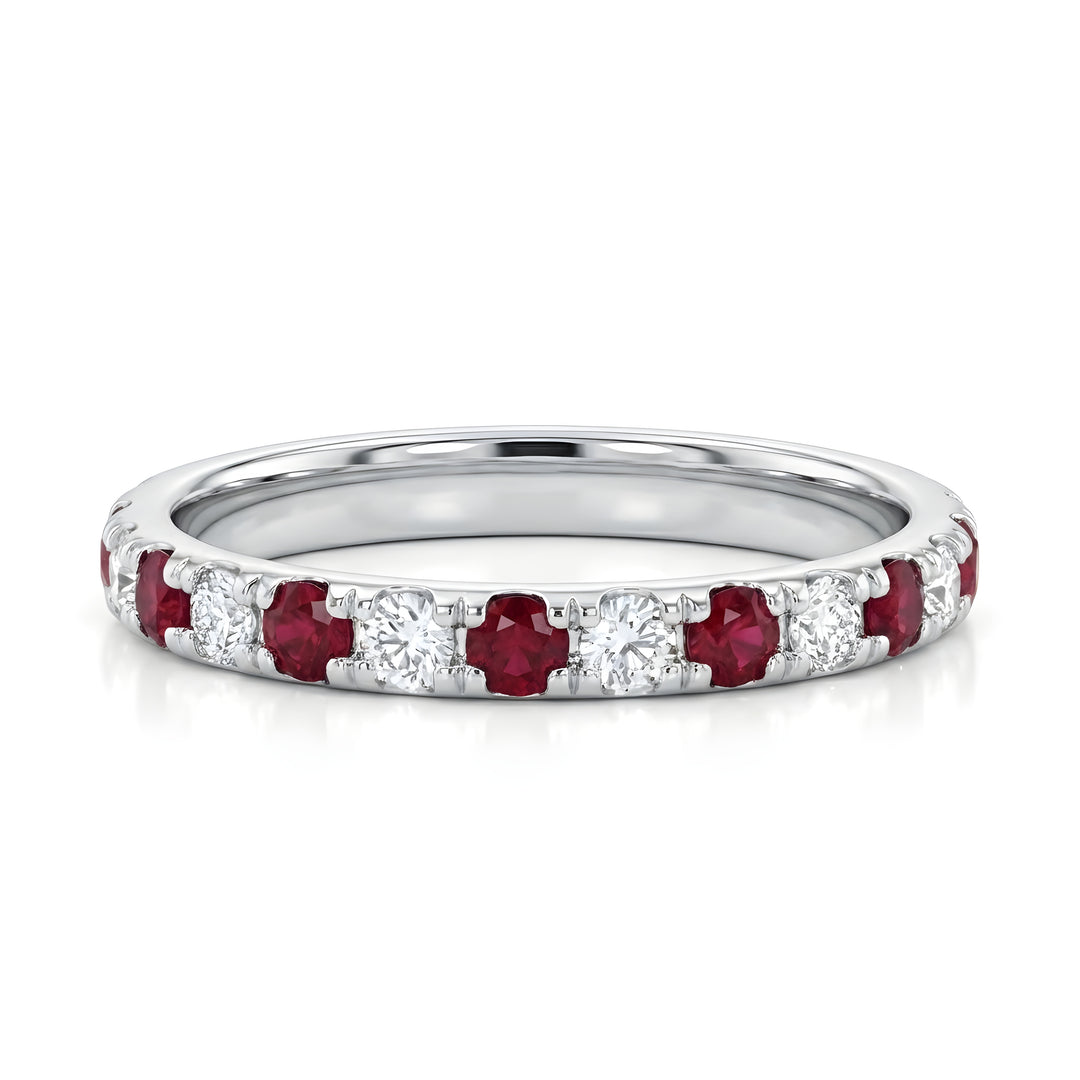 Elegant white gold ring featuring alternating round red rubies and sparkling white diamonds. The sleek design conveys luxury and sophistication.