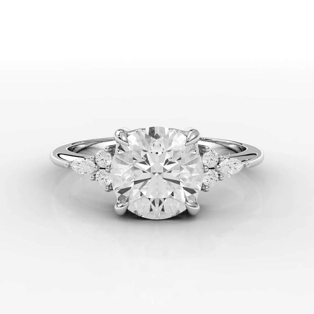 Elegant white gold ring with a large round diamond centerpiece, flanked by smaller marquise and round diamonds on each side, on a reflective surface.