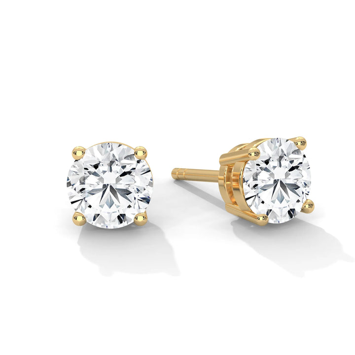 Elegant yellow gold diamond stud earrings sparkling with brilliance perfect for adding a touch of luxury to any outfit.