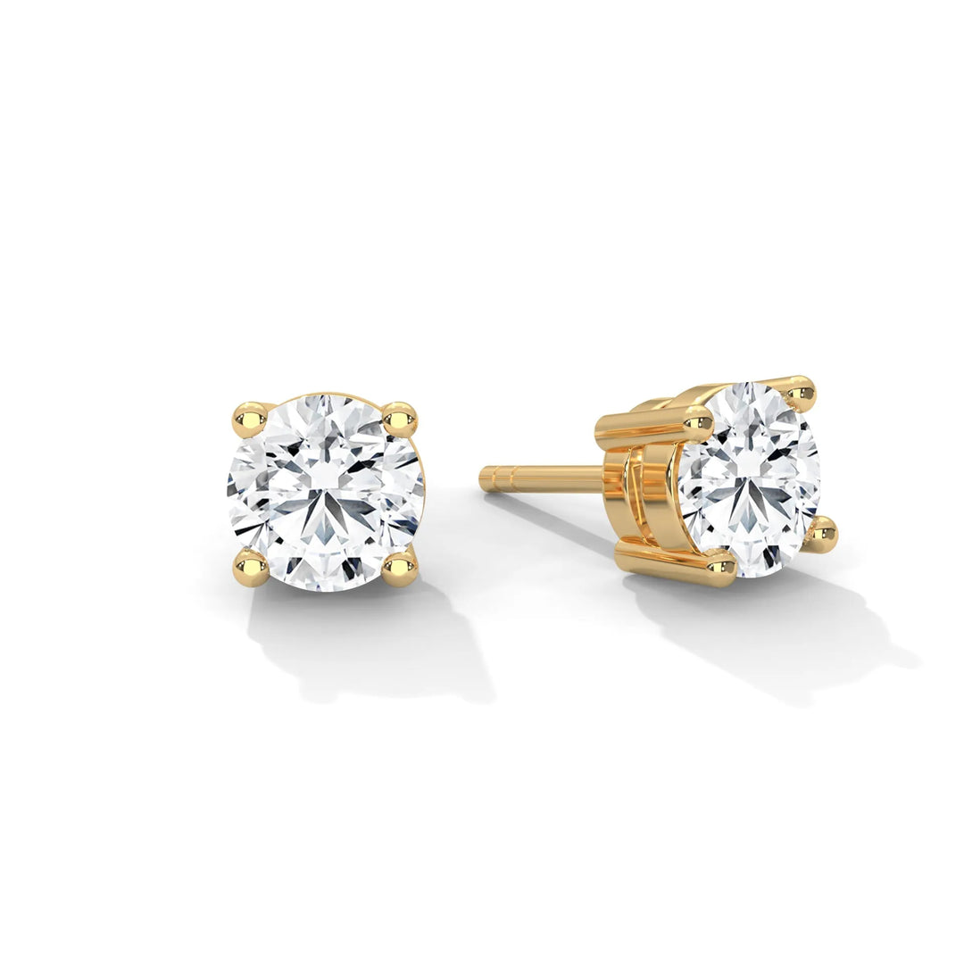 Elegant yellow gold diamond stud earrings sparkling with brilliance perfect for adding a touch of luxury to any outfit.