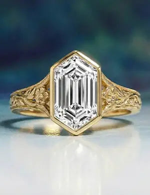 Vintage gold engagement ring with an emerald-cut diamond and intricate floral detailing