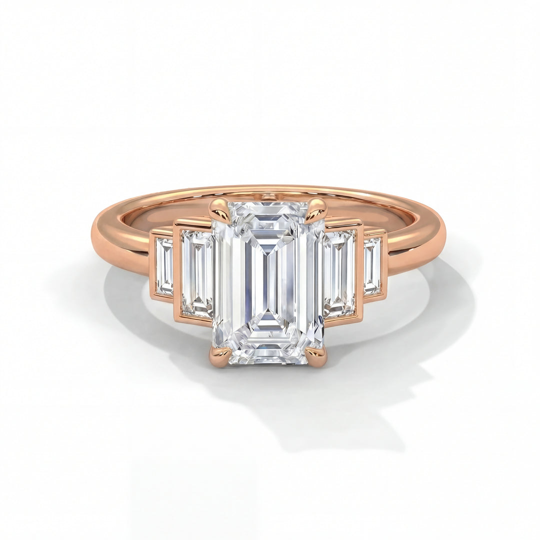 Emerald cut diamond engagement ring in rose gold with graduated baguette step side stones and classic four prong setting