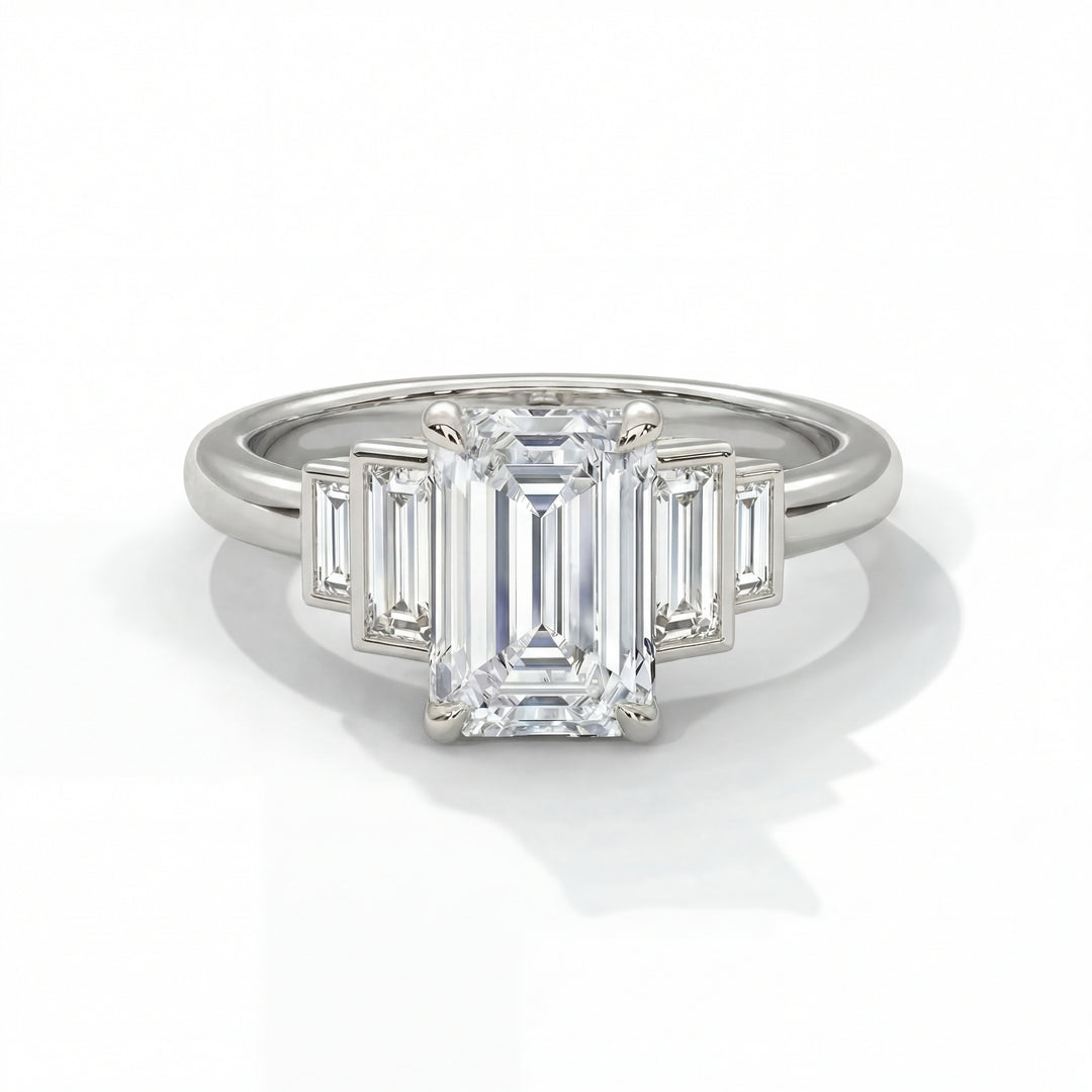 Emerald cut diamond engagement ring in white gold with graduated baguette step side stones and classic four prong setting