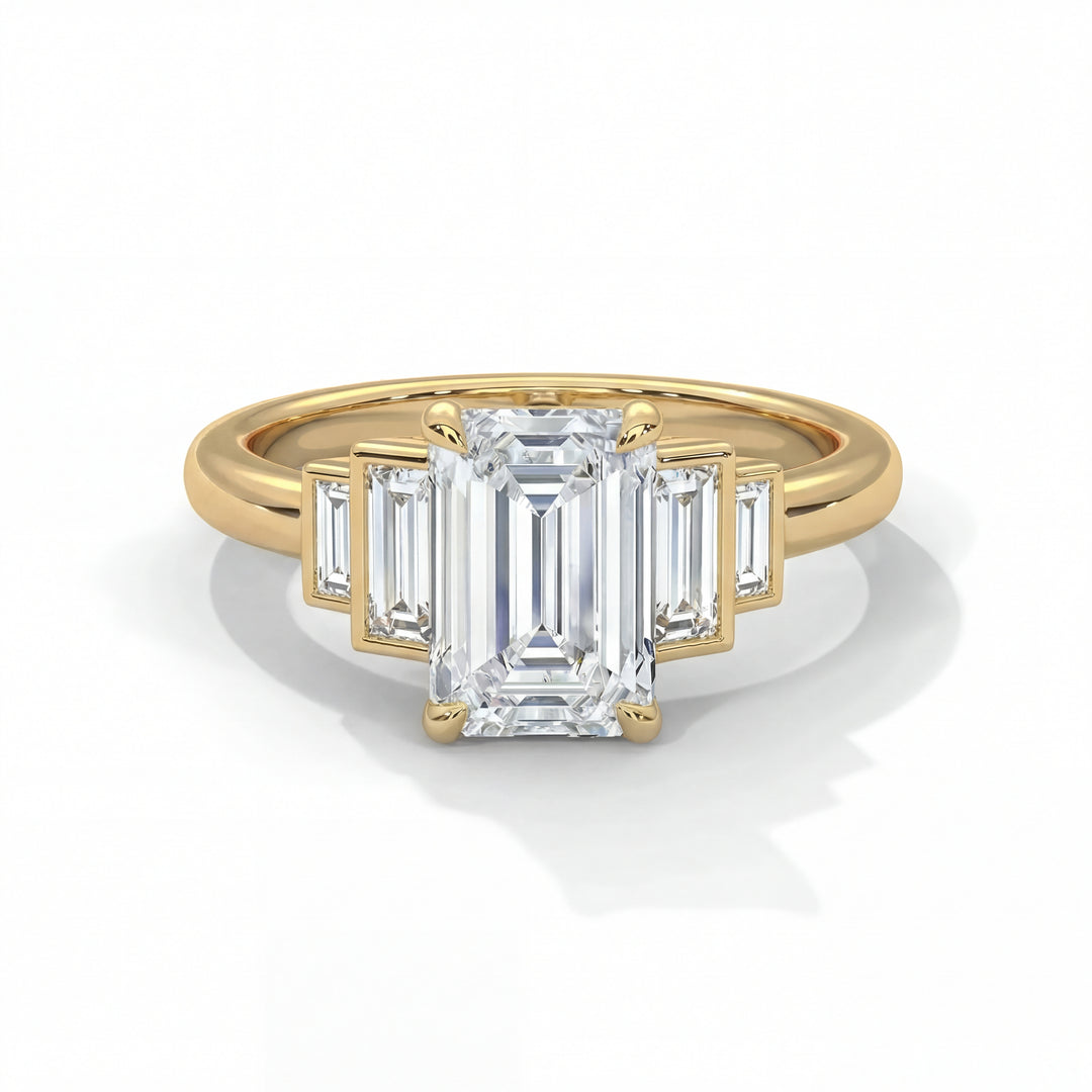 Emerald cut diamond engagement ring in yellow gold with graduated baguette step side stones and classic four prong setting