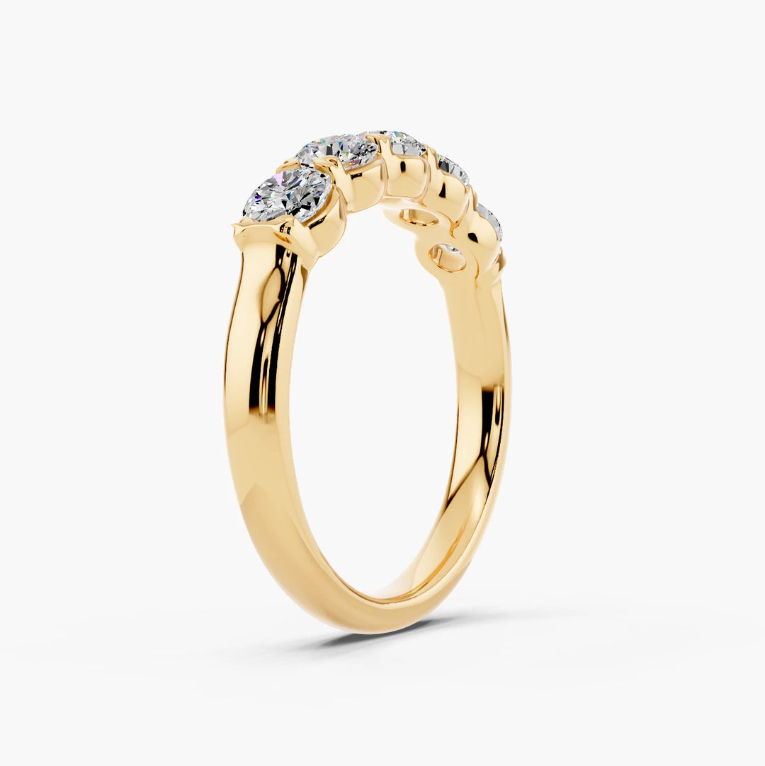 Five stone classic basket diamond ring in yellow gold, angled view