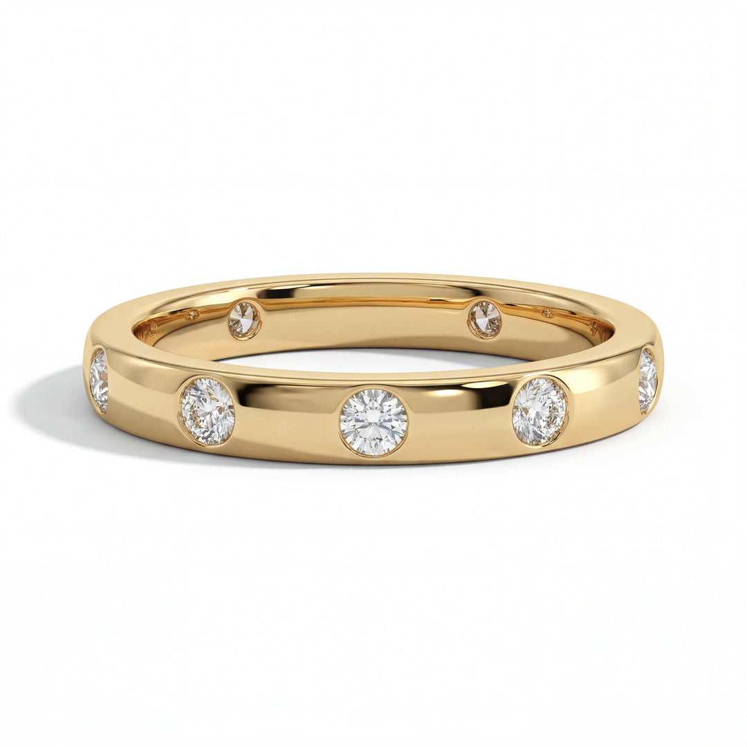 A gold band embedded with small, round diamonds evenly spaced around the ring, set against a white background, conveying elegance and luxury.