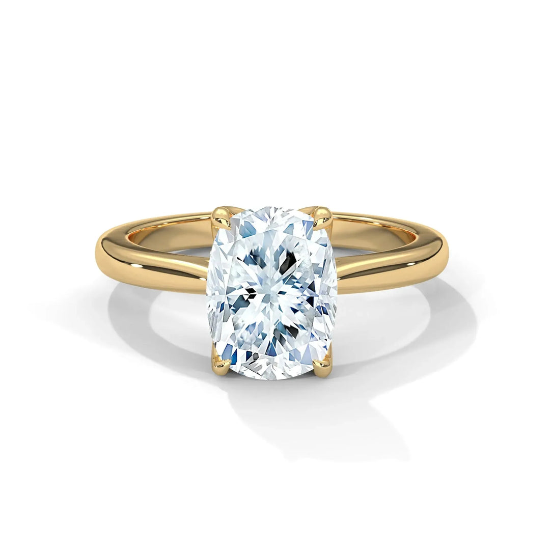 A gold band ring with a large, oval-cut diamond at the center, reflecting light. The setting is elegant and simple, giving a luxurious feel.