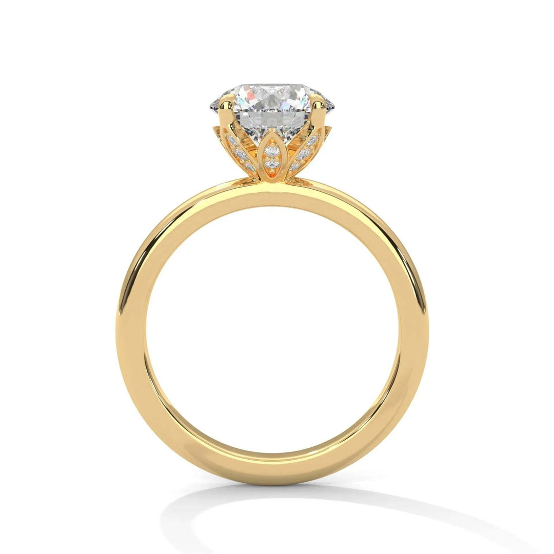Gold engagement ring with a large, round diamond set in an ornate prong setting. The design is elegant, showcasing brilliance and luxury.