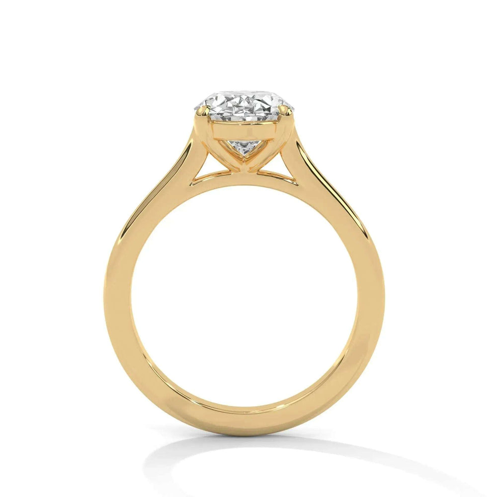 A gold engagement ring with a large round diamond set in a simple prong setting. The polished band reflects light, conveying elegance and sophistication.