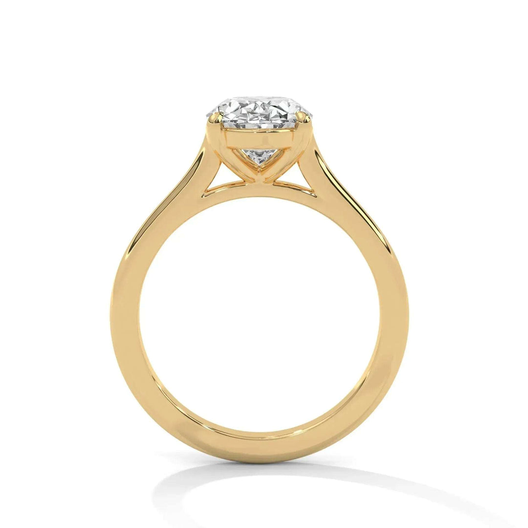 A gold engagement ring with a large round diamond set in a simple prong setting. The polished band reflects light, conveying elegance and sophistication.