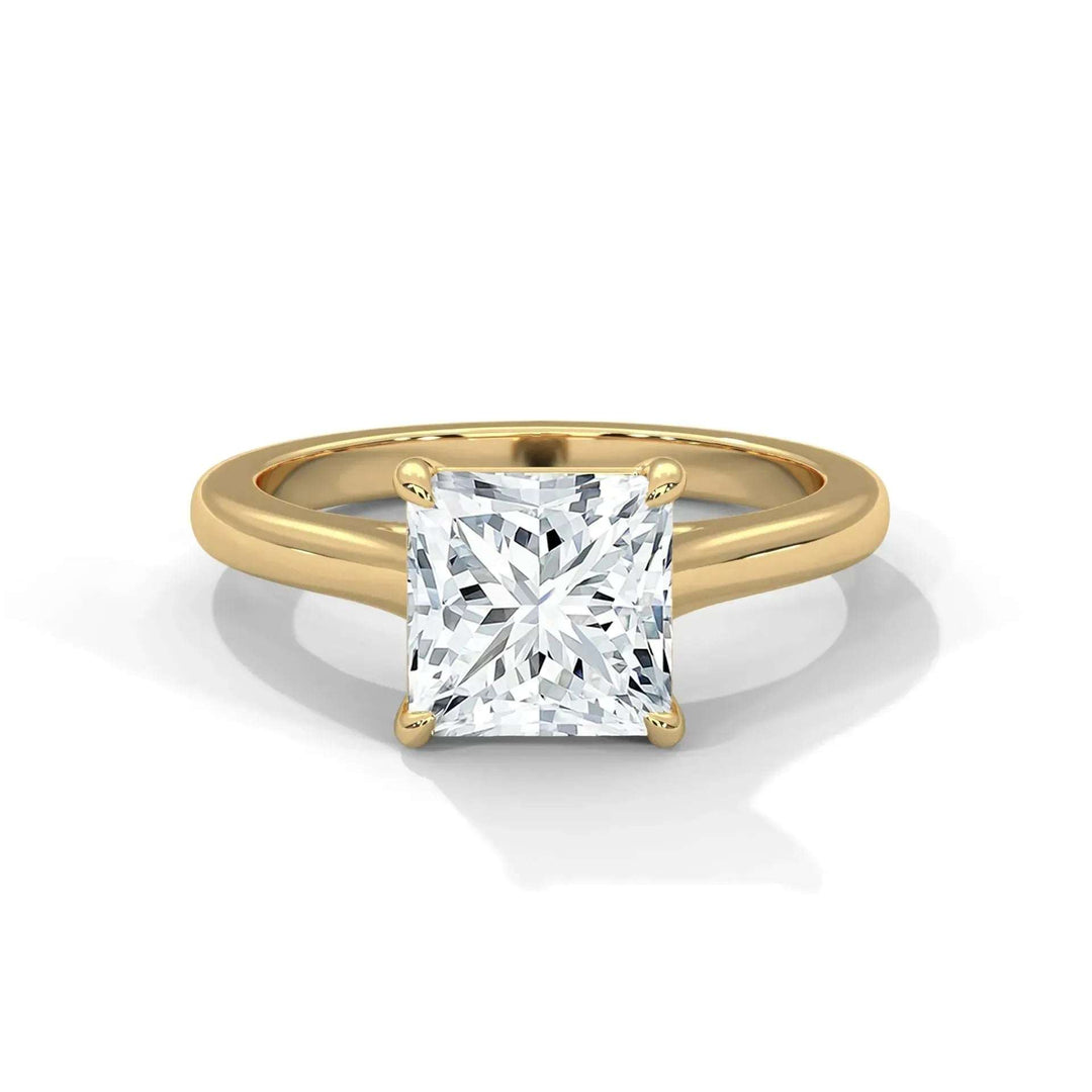A gold engagement ring with a large, square-cut diamond set in a simple band. The diamond sparkles, highlighting its facets, exuding elegance and luxury.