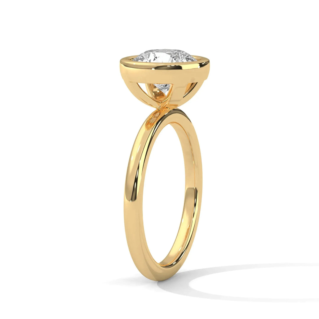A gold engagement ring with a prominent round diamond in a prong setting. The polished band reflects light, conveying elegance and sophistication.