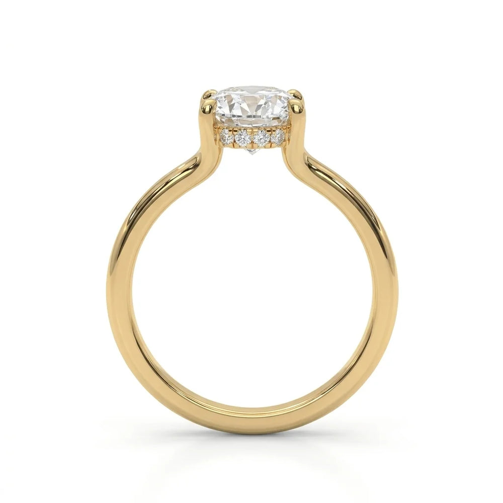 A gold engagement ring with a round diamond solitaire setting. The ring features a row of small diamonds below the main stone, exuding elegance and luxury.