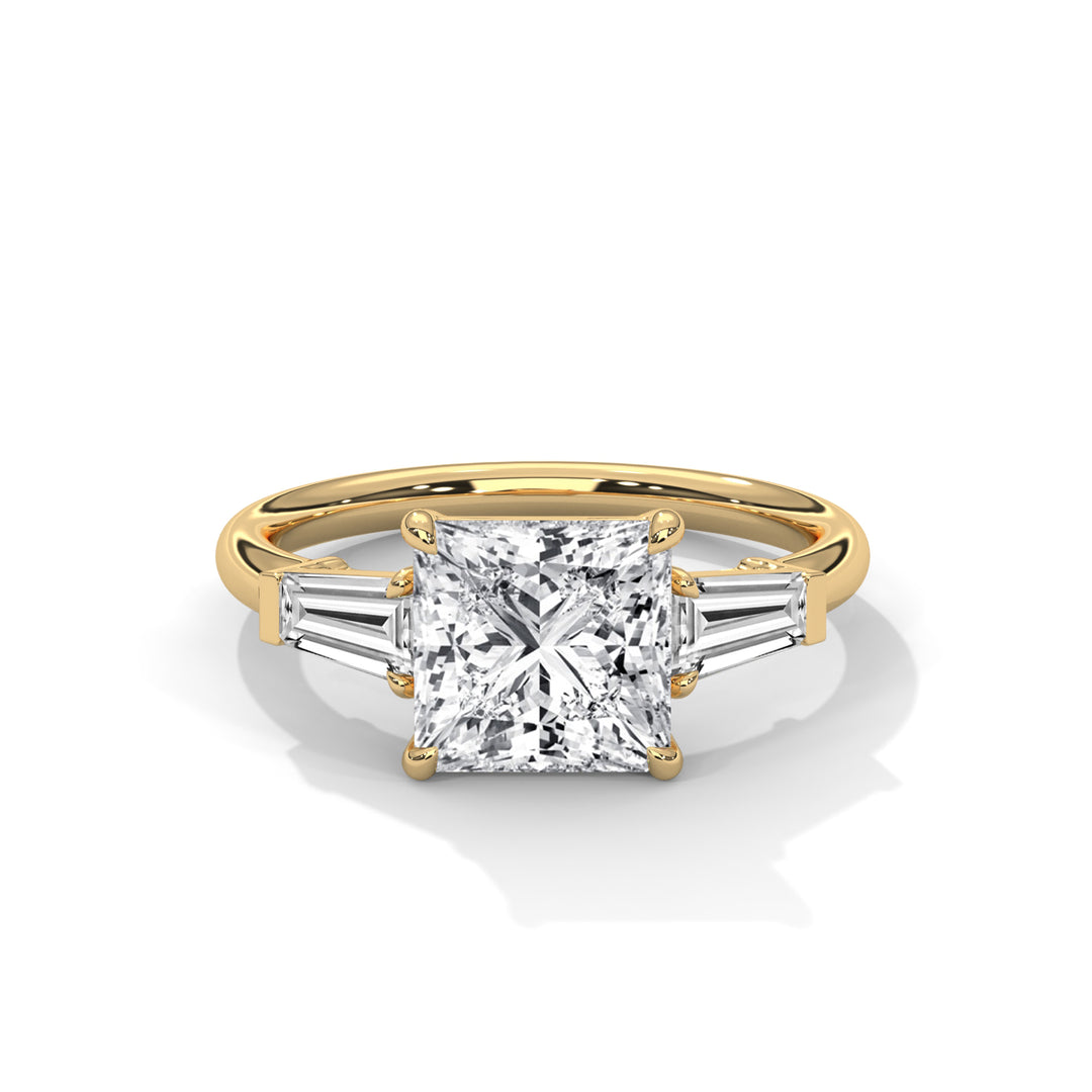 Gold engagement ring with a square, radiant-cut diamond center and two tapered baguette diamonds on either side, exuding elegance and sophistication.