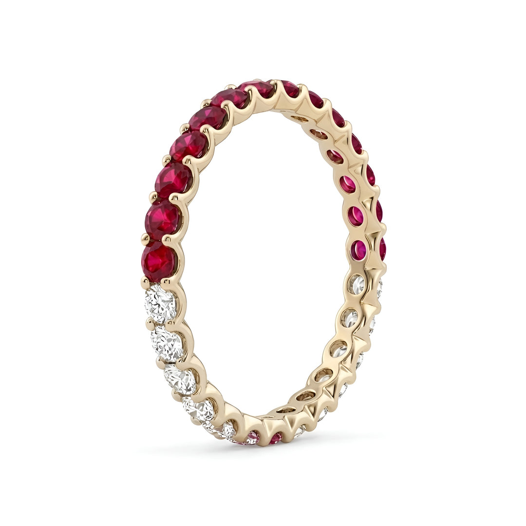 A gold eternity band adorned with alternating deep red rubies and sparkling white diamonds, creating an elegant and luxurious appearance.