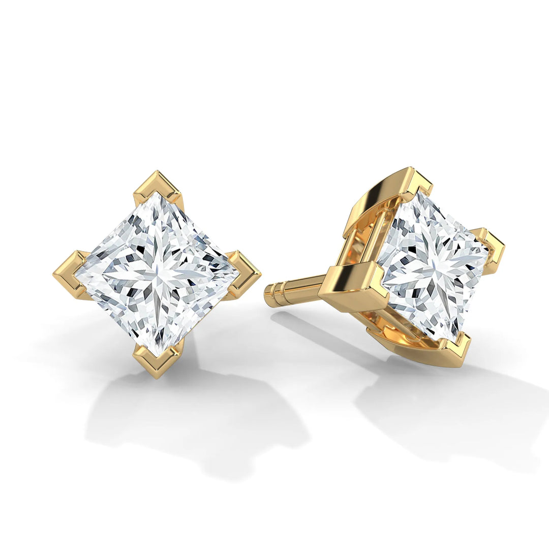 Gold princess cut diamond stud earrings on a white background.