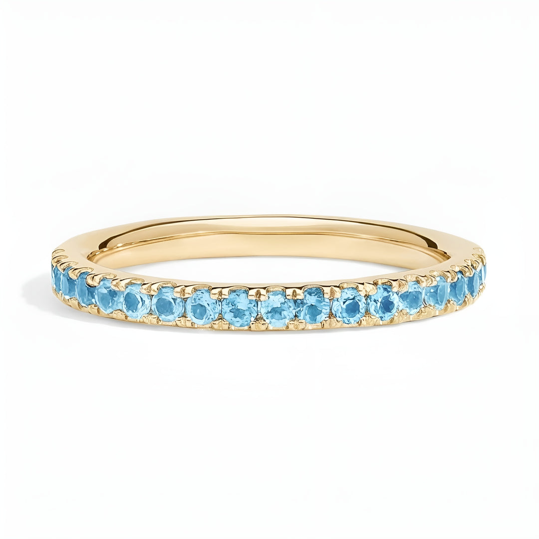 Gold ring with blue gemstones on a white background