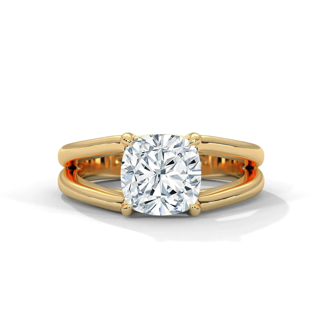 A gold ring with a cushion-cut diamond sits prominently, featuring a split shank design. The setting conveys elegance and luxury with a reflective shine.