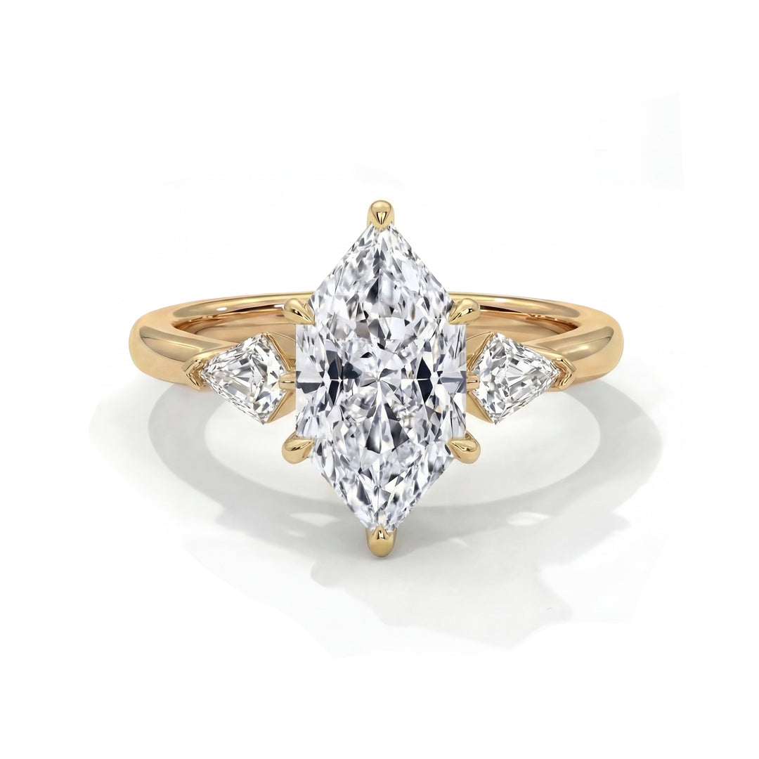 A gold ring featuring a large marquise-cut diamond flanked by two smaller triangle diamonds. The elegant, reflective design conveys luxury and sophistication.
