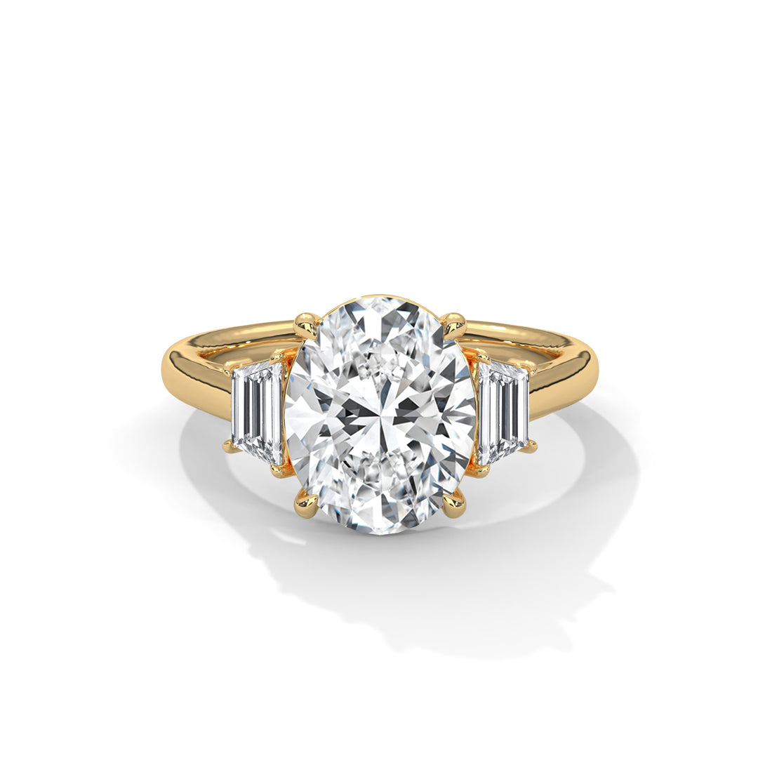 A gold ring featuring a large oval diamond at the center, flanked by two baguette diamonds. The design is elegant and luxurious, conveying sophistication.
