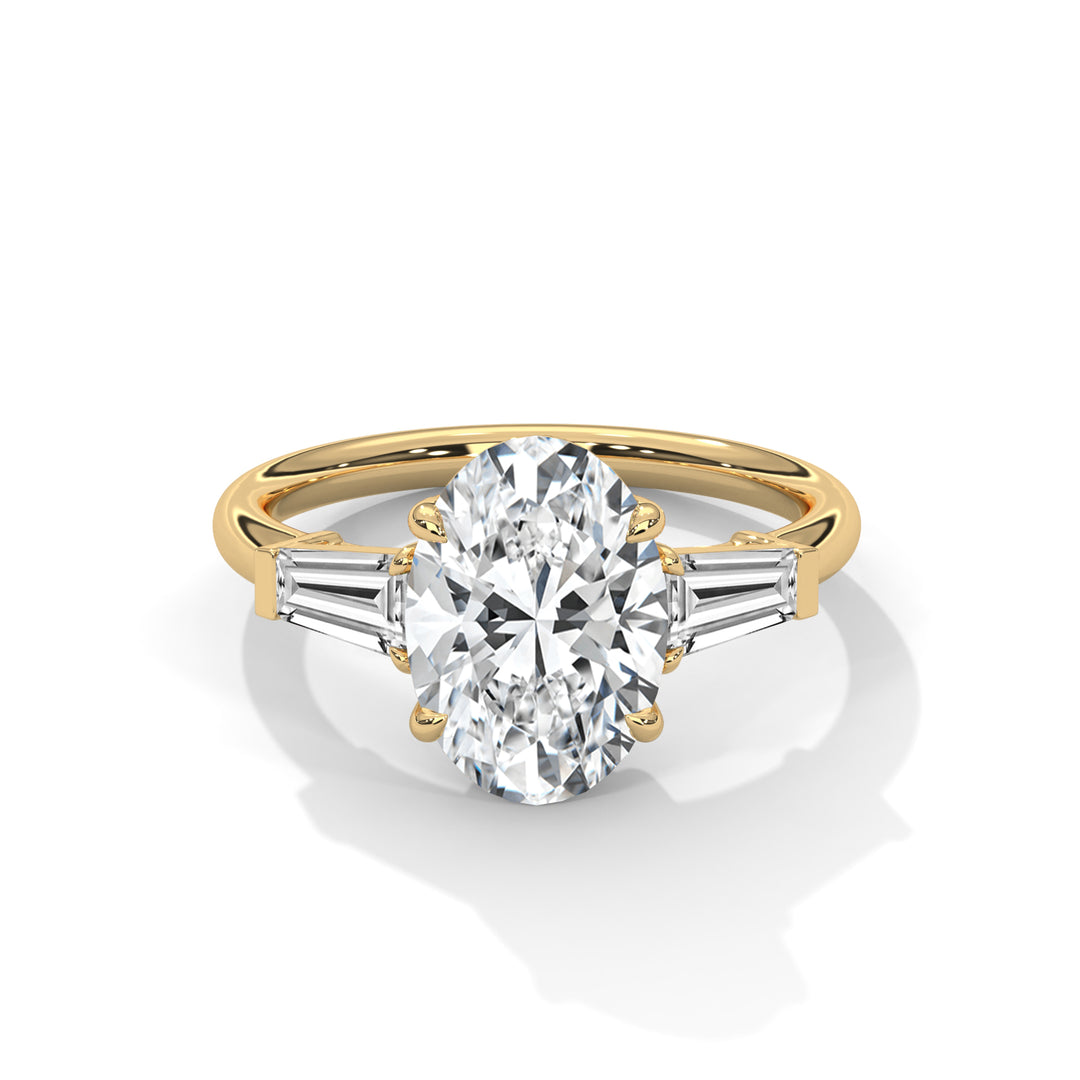 A gold ring featuring an oval diamond centerpiece flanked by tapered baguette diamonds. The design is elegant, showcasing luxury and sophistication.
