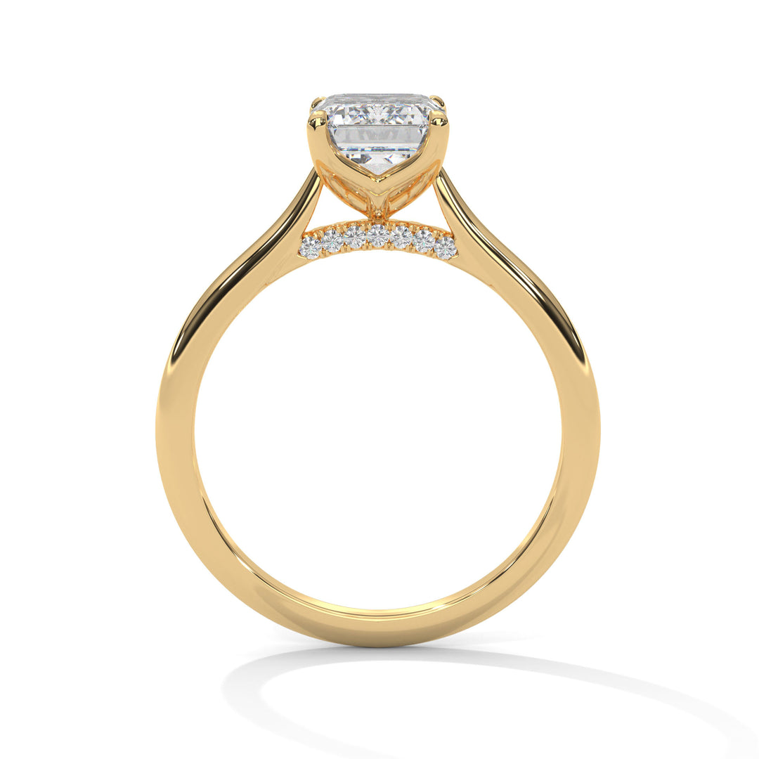 Gold ring with a heart-shaped diamond on a white background