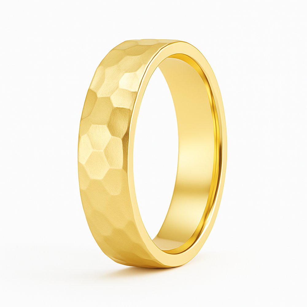 A gold ring with a hexagonal hammered texture, displayed against a white background. The surface subtly catches the light, conveying elegance.