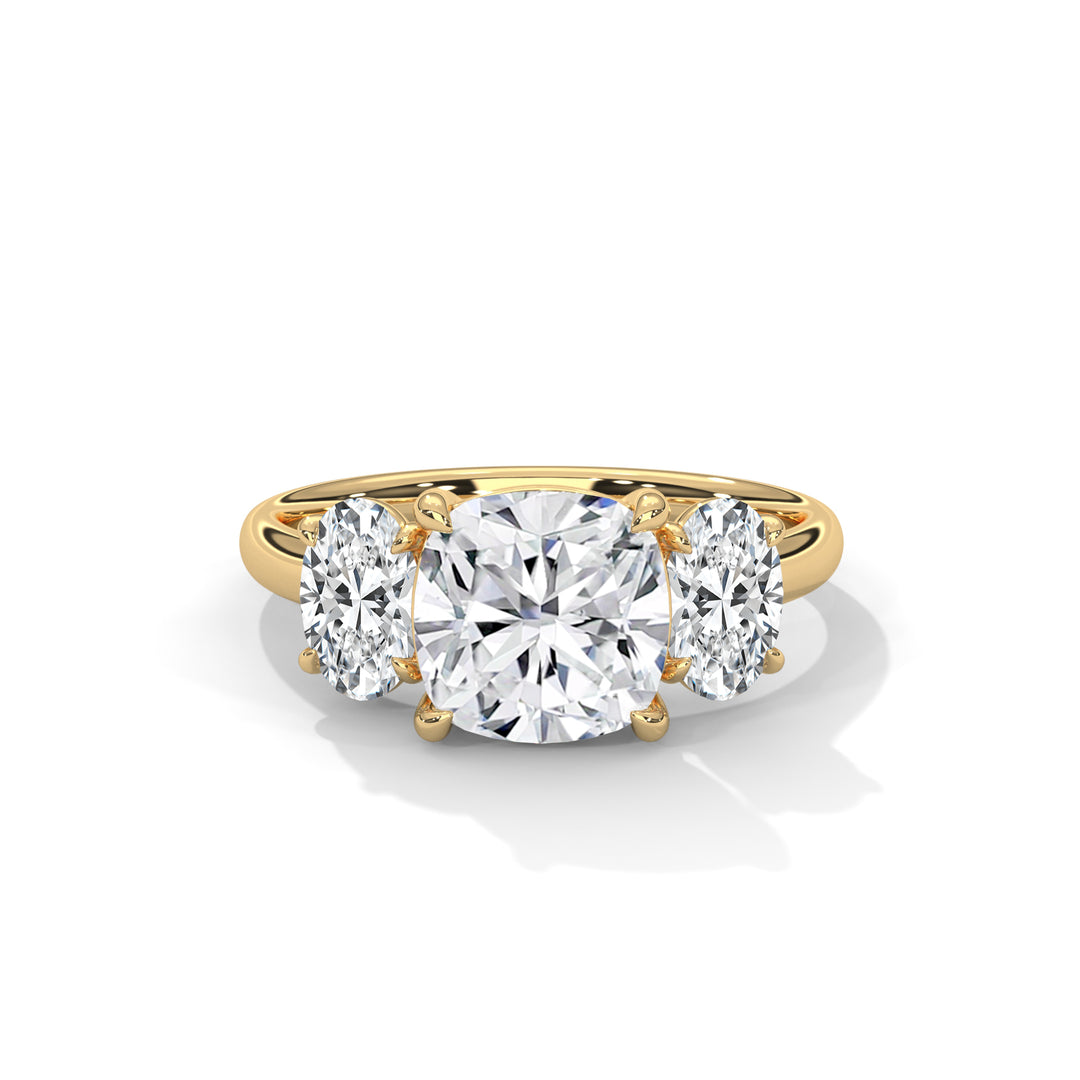 Gold ring with a large central diamond flanked by two smaller diamonds, set on a polished band. The elegant design conveys a sense of luxury.