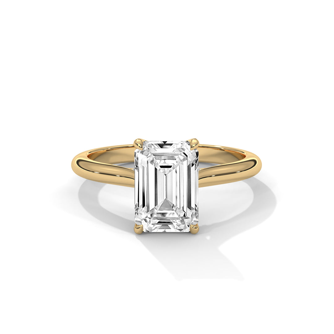 Gold ring with a large diamond on a white background