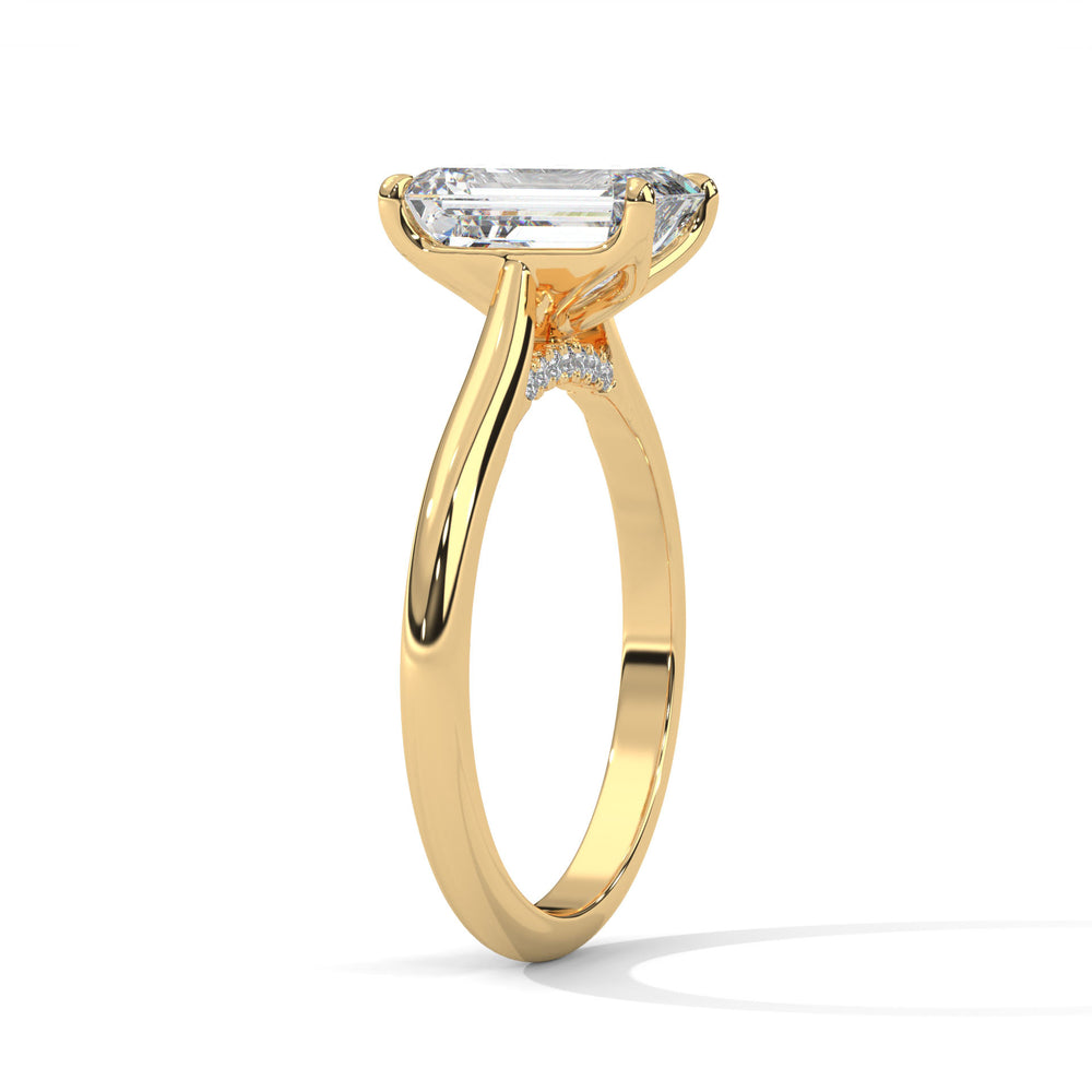 Gold ring with a large diamond on a white background