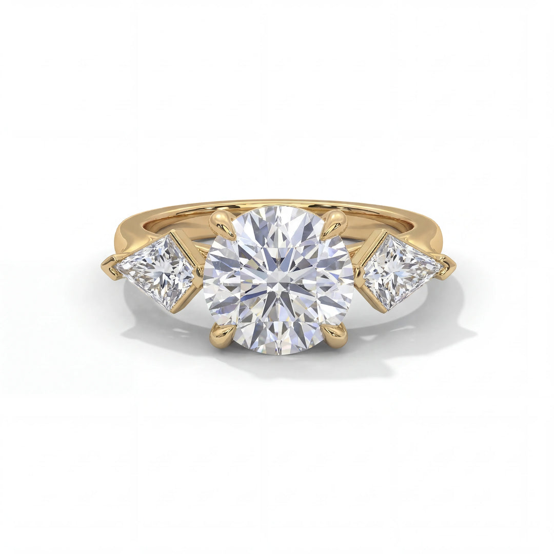 A gold ring with a large round diamond centerpiece flanked by two smaller triangular diamonds, creating a classic and elegant design.