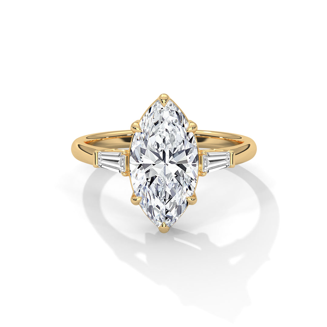 Gold ring with a marquise-cut diamond centerpiece flanked by tapered baguette diamonds on each side, conveying elegance and luxury.